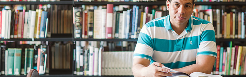 student_testimonials man studying in sullivan university's library