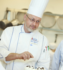 Chef David Woolums 220x245 Chef David Woolums pointing something out in the kitchen