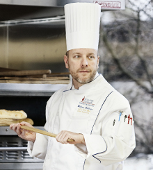 William Hallman 220x245 Chef William Hallman taking bread out of the oven