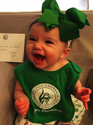 riley baby wearing a Sullivan University college of pharmacy future pharmacist bib