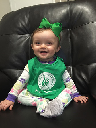 baby wearing a Sullivan University college of pharmacy future pharmacist bib