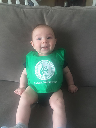baby wearing a Sullivan University college of pharmacy future pharmacist bib