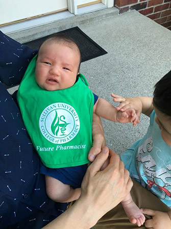 baby wearing a Sullivan University college of pharmacy future pharmacist bib
