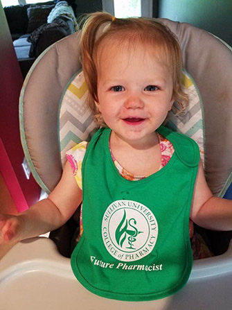 4 baby wearing a Sullivan University college of pharmacy future pharmacist bib