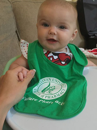 baby wearing a Sullivan University college of pharmacy future pharmacist bib