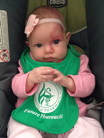 baby wearing a Sullivan University college of pharmacy future pharmacist bib